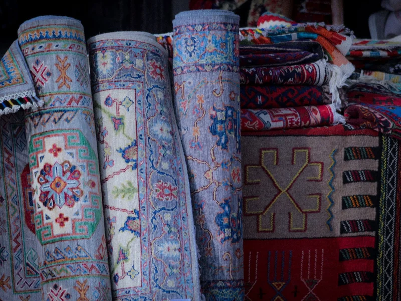 Area rug cleaning specialist inspecting an oriental rug in Warren, MI